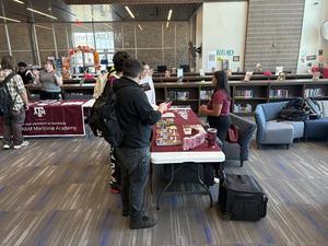 Students gather recruiting materials from Texas A&M representatives