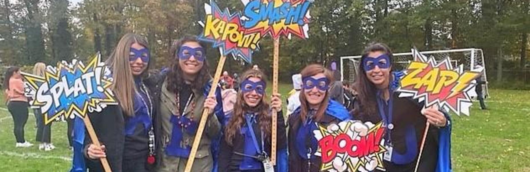 Photo of Tamaques staff members dressed as superheroes for Halloween.