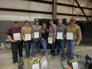 welding students and teacher posing for photo with awards