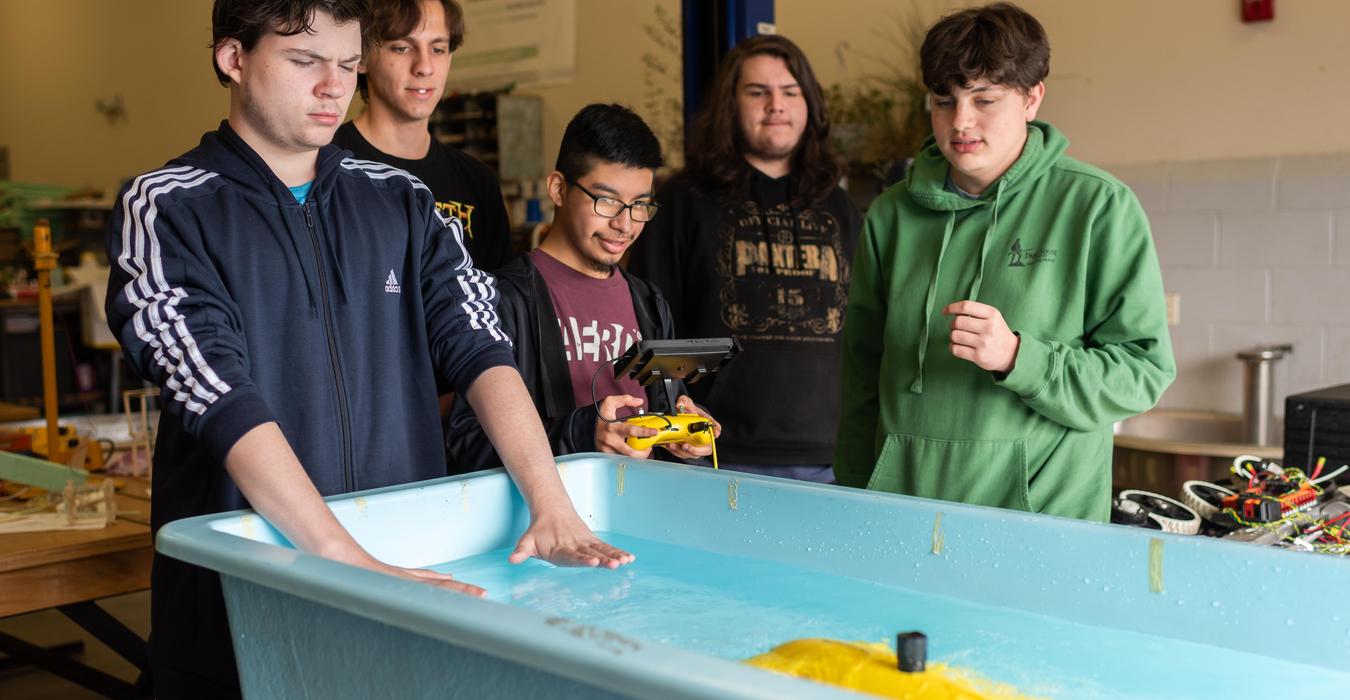 Students working with technology equipment.