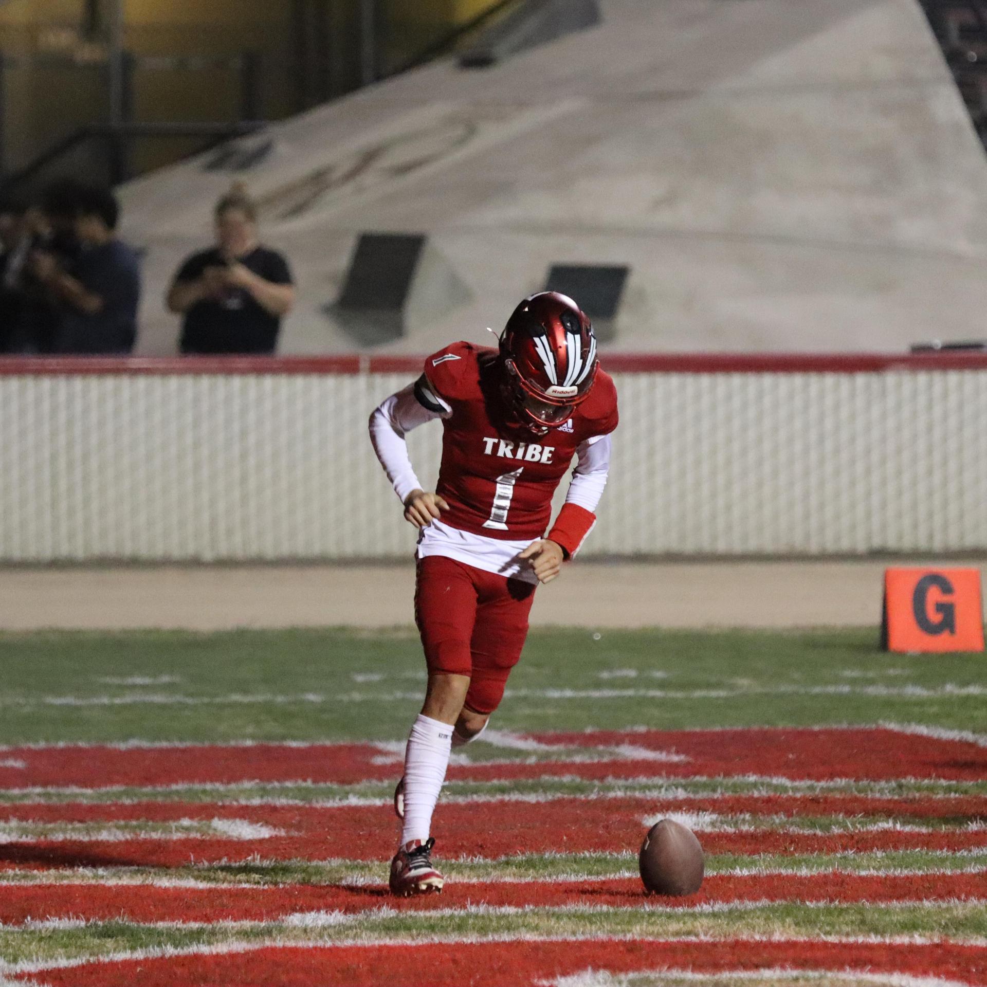 varsity football players in action against Riverdale