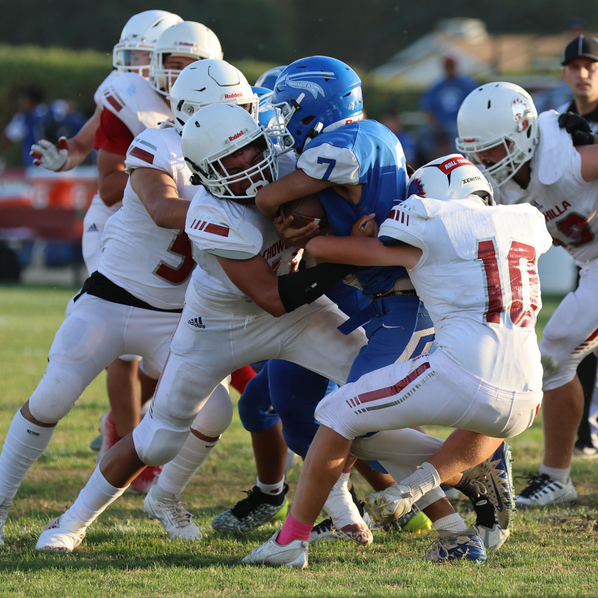 Junior Varsity football players in action against Caruthers