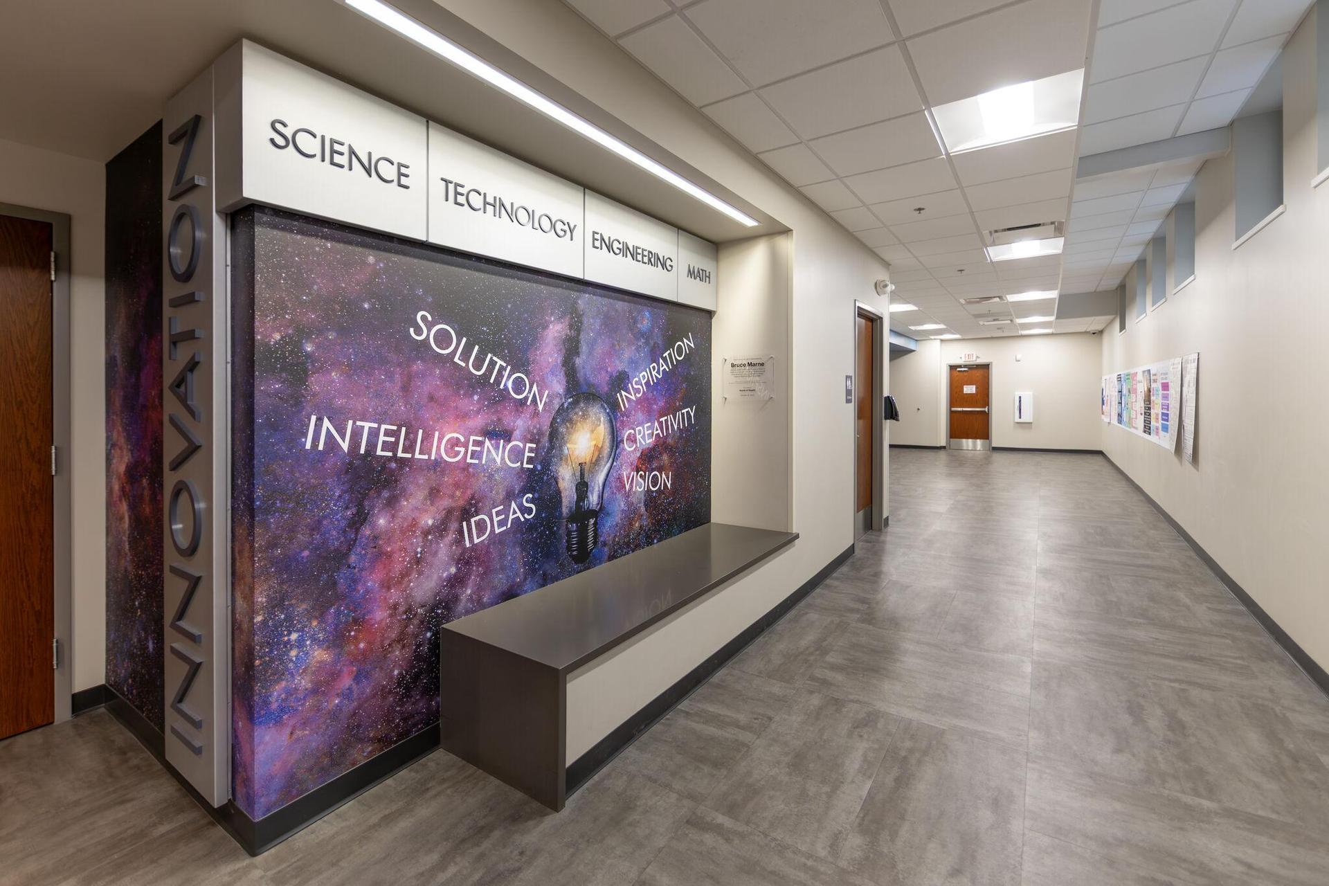 The hallway outside the new Innovation Lab, which has a purple galaxy photo on the wall.
