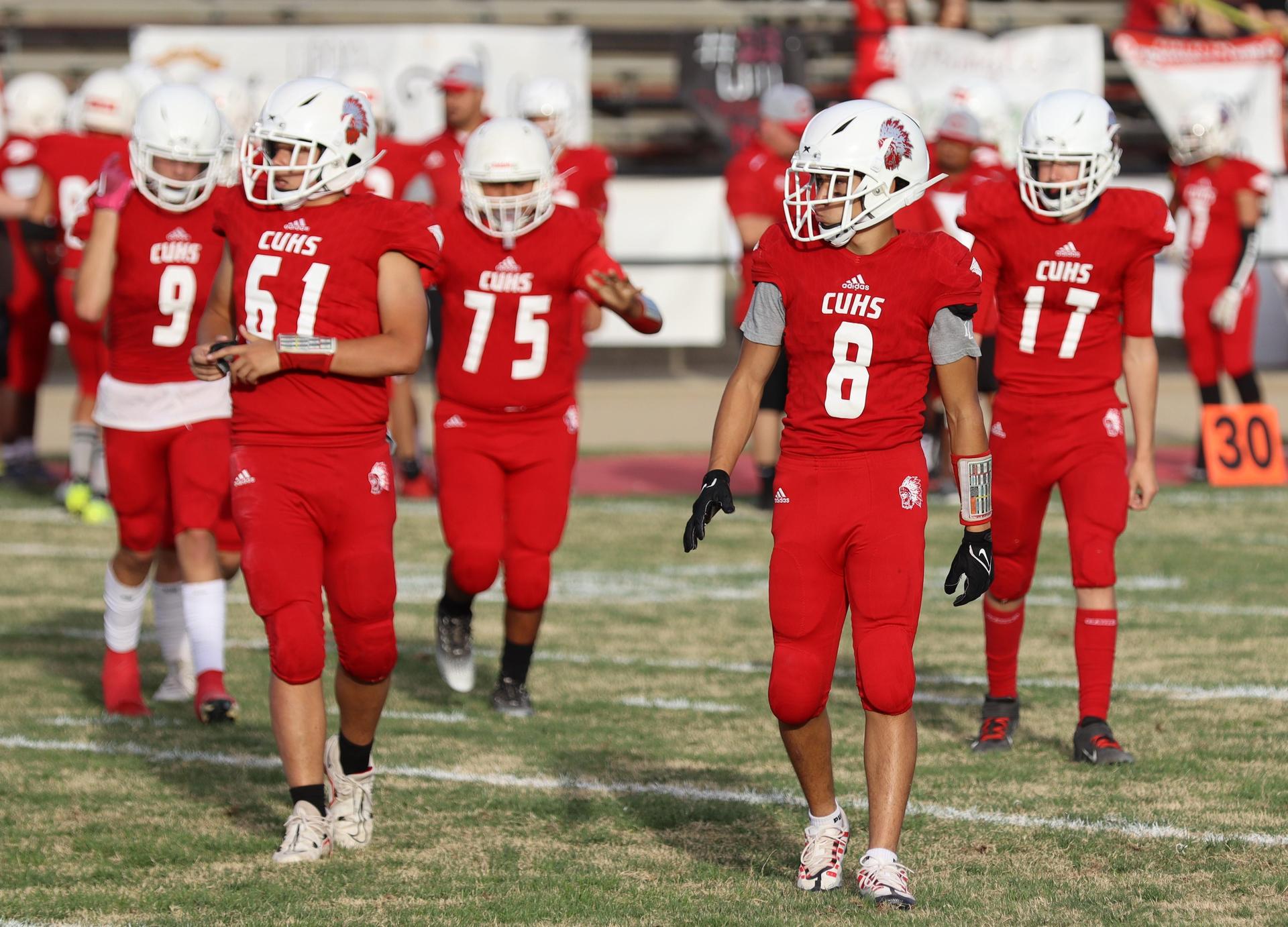  junior varsity football players in action against riverdale