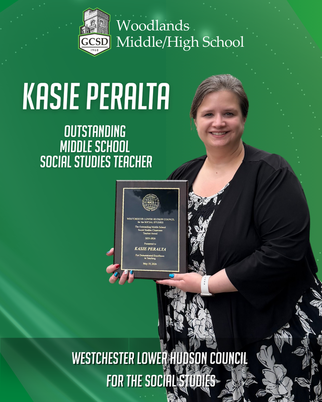 Ms. Peralta holds plaque showing award