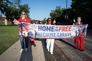 Teachers carry a banner to lead the Freedom Walk at Scott Elementary