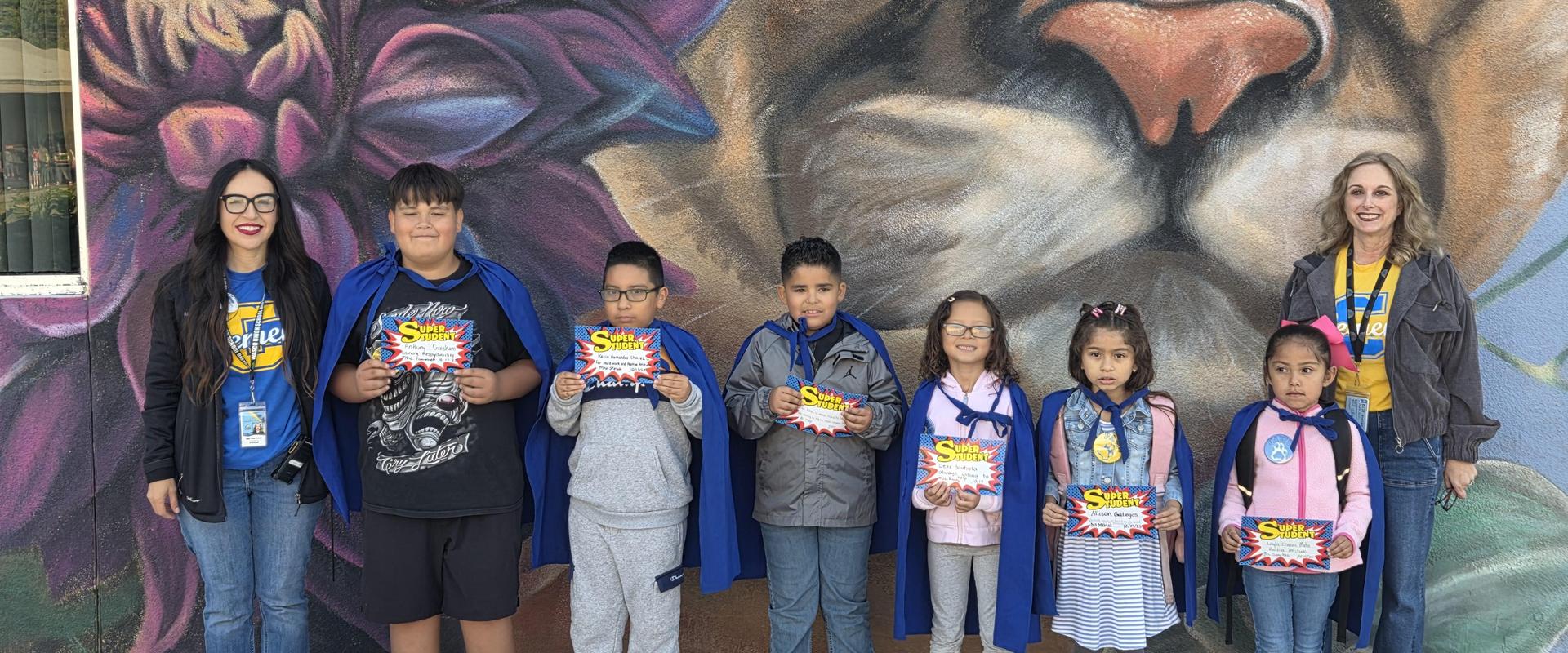 Super students with principal and vice principal