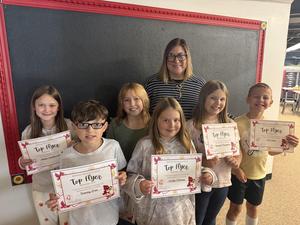 Students displaying certificates with the principal.