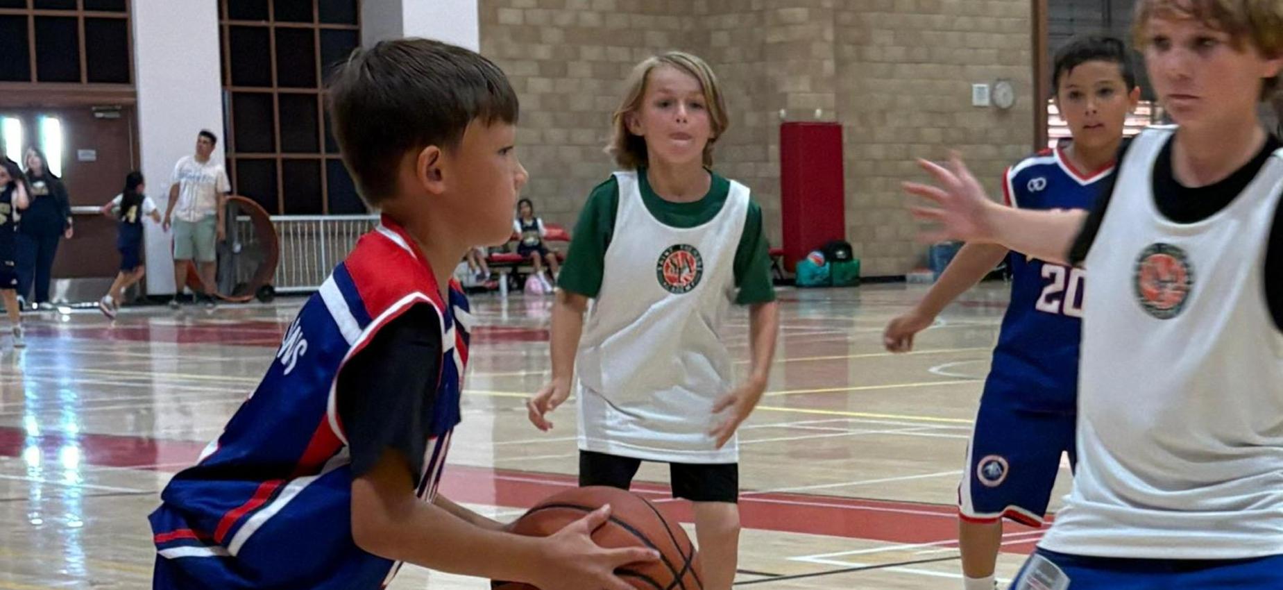 3rd grade basketball player shoots the ball