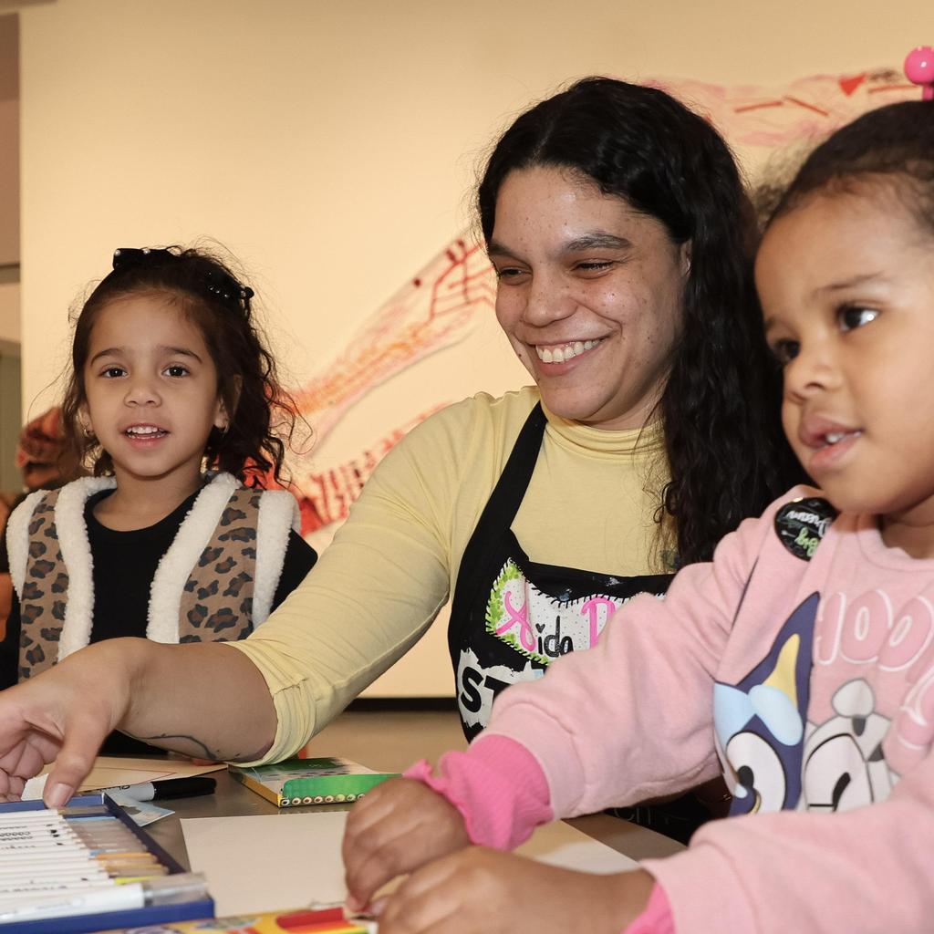 Children and teacher working on art