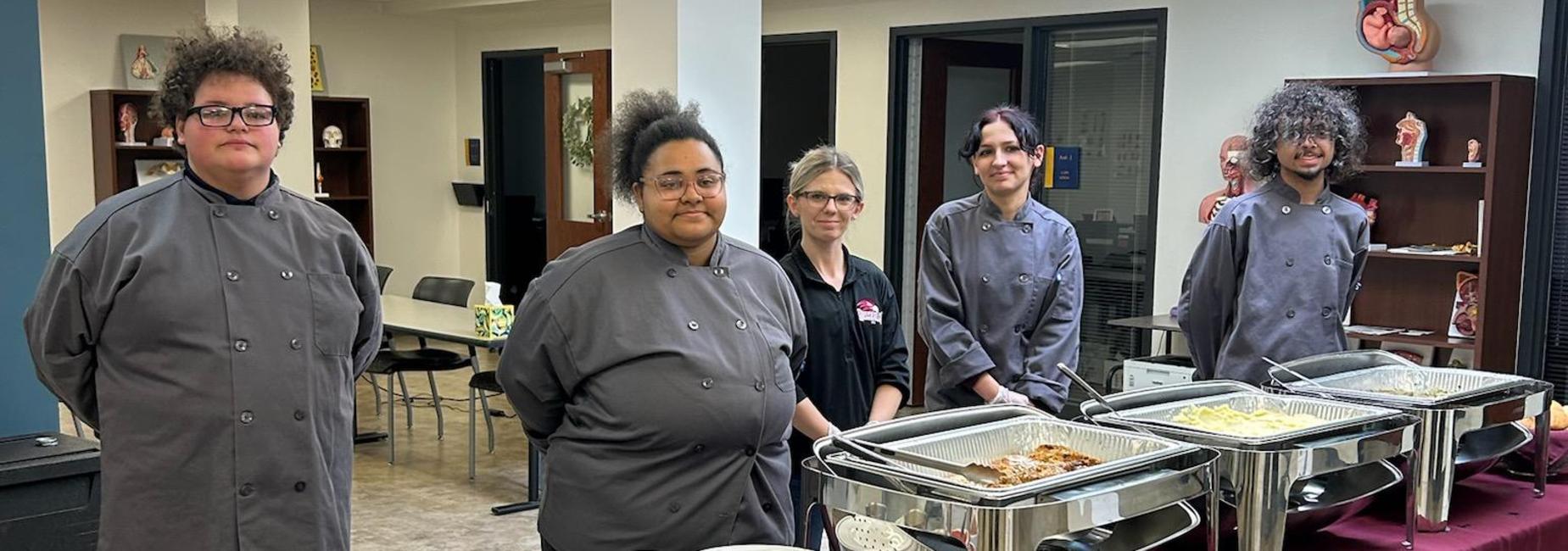 four career center students preparing to serve a meal