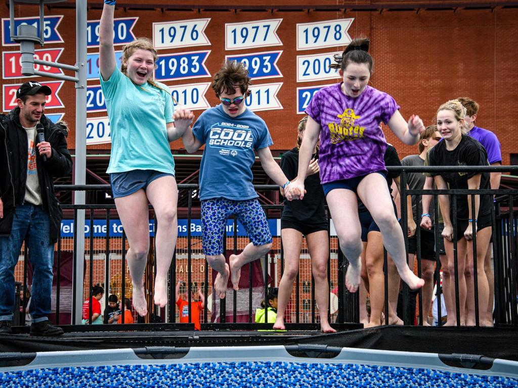 Three students taking the Polar Plunge into a cold swimming pool.