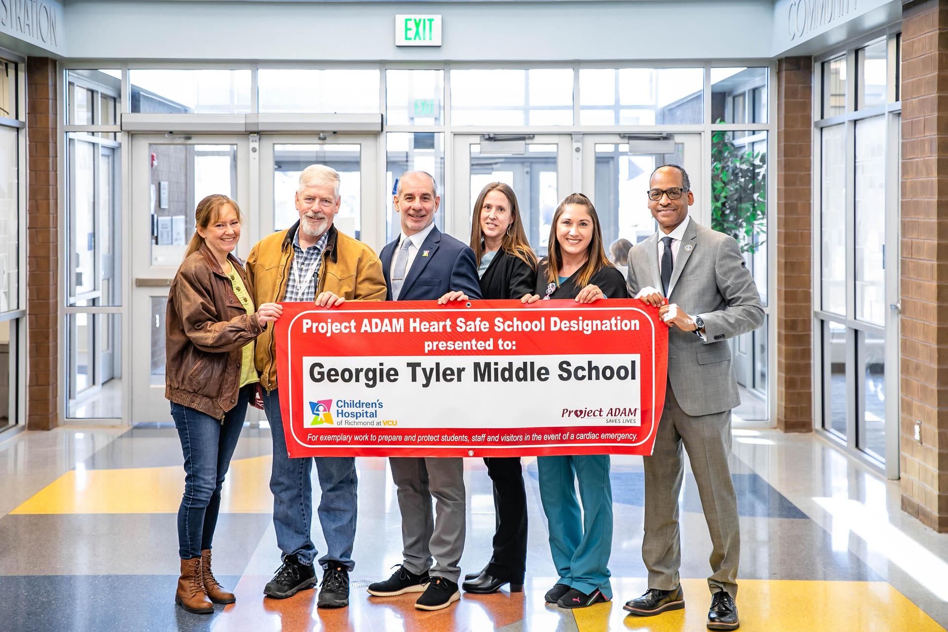 GTMS Project Adam team holding banner