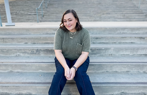 Assistant Principal Guthrie sits on steps.