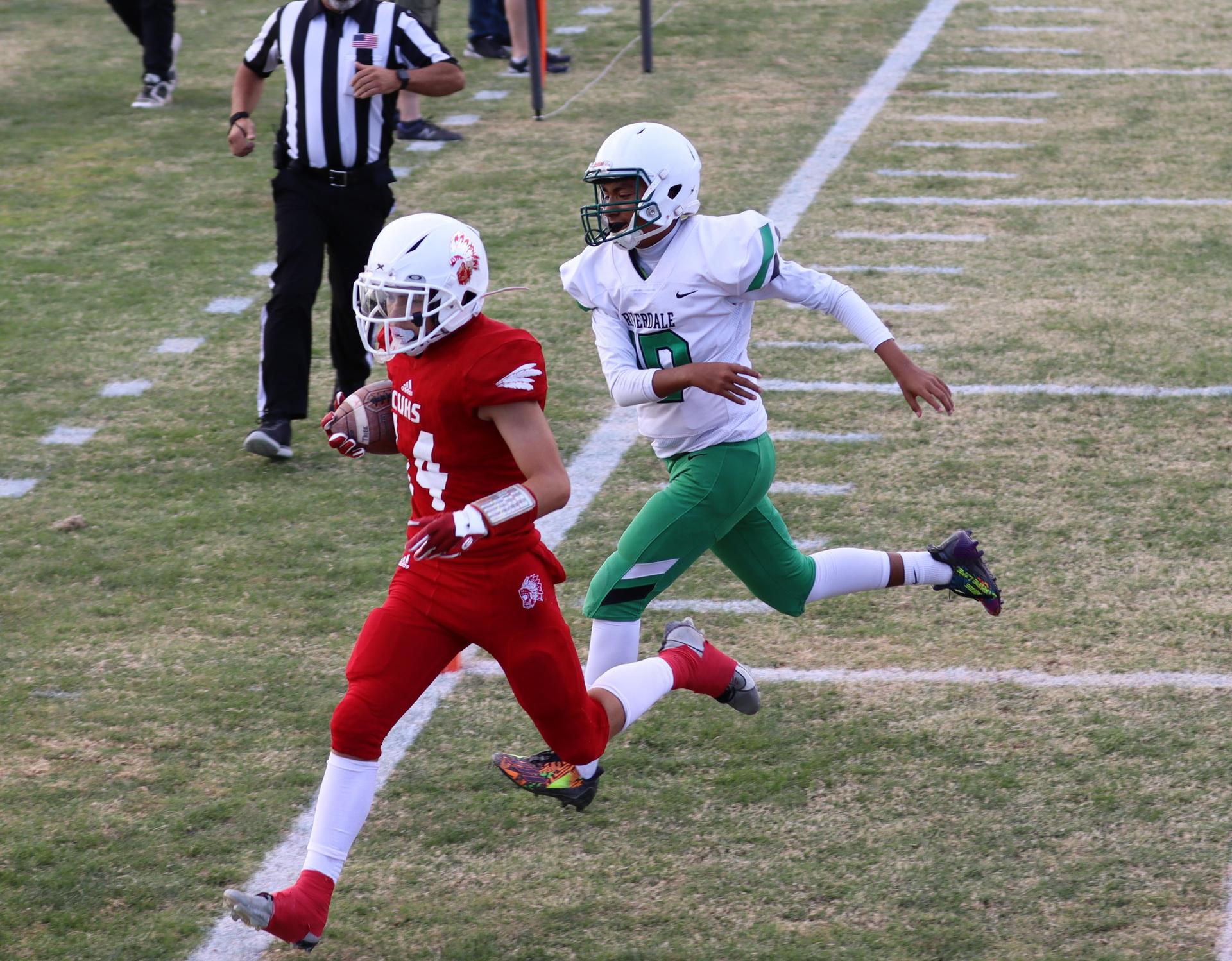  junior varsity football players in action against riverdale