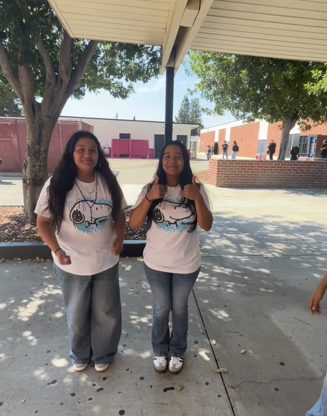 two students are wearing white shirts and jeans in support of spirit week