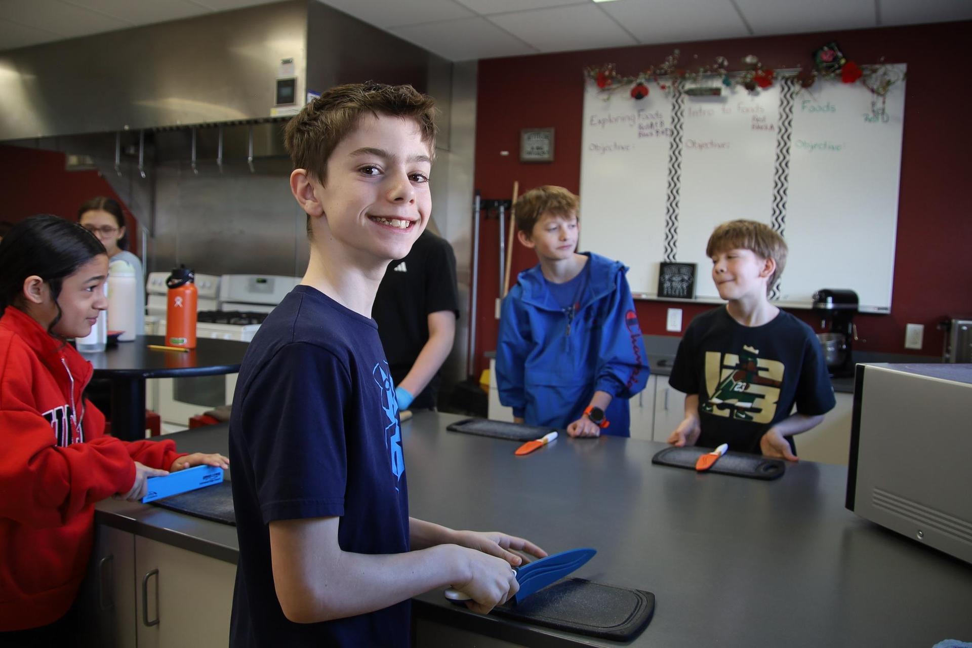 Student smiling in a cooking classroom