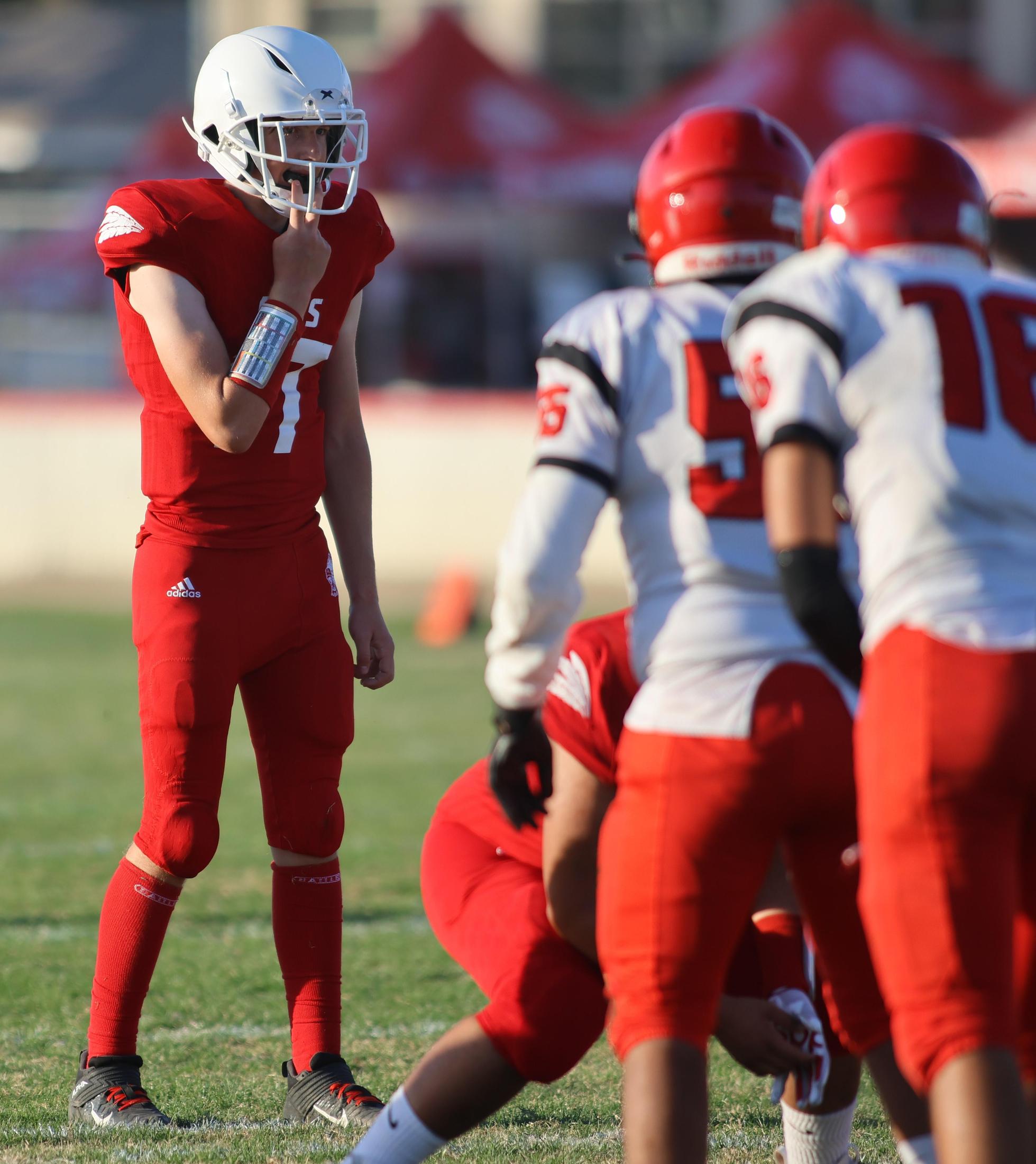 junior varsity football players in action against Fowler