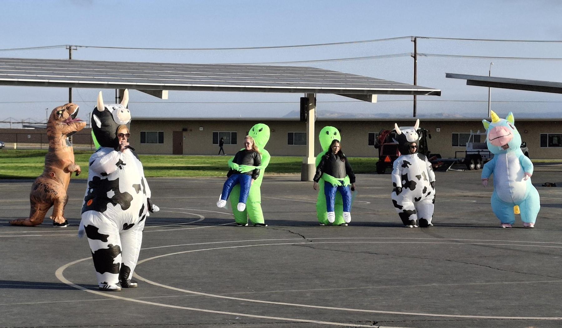 Teachers dressed in inflatable costumes