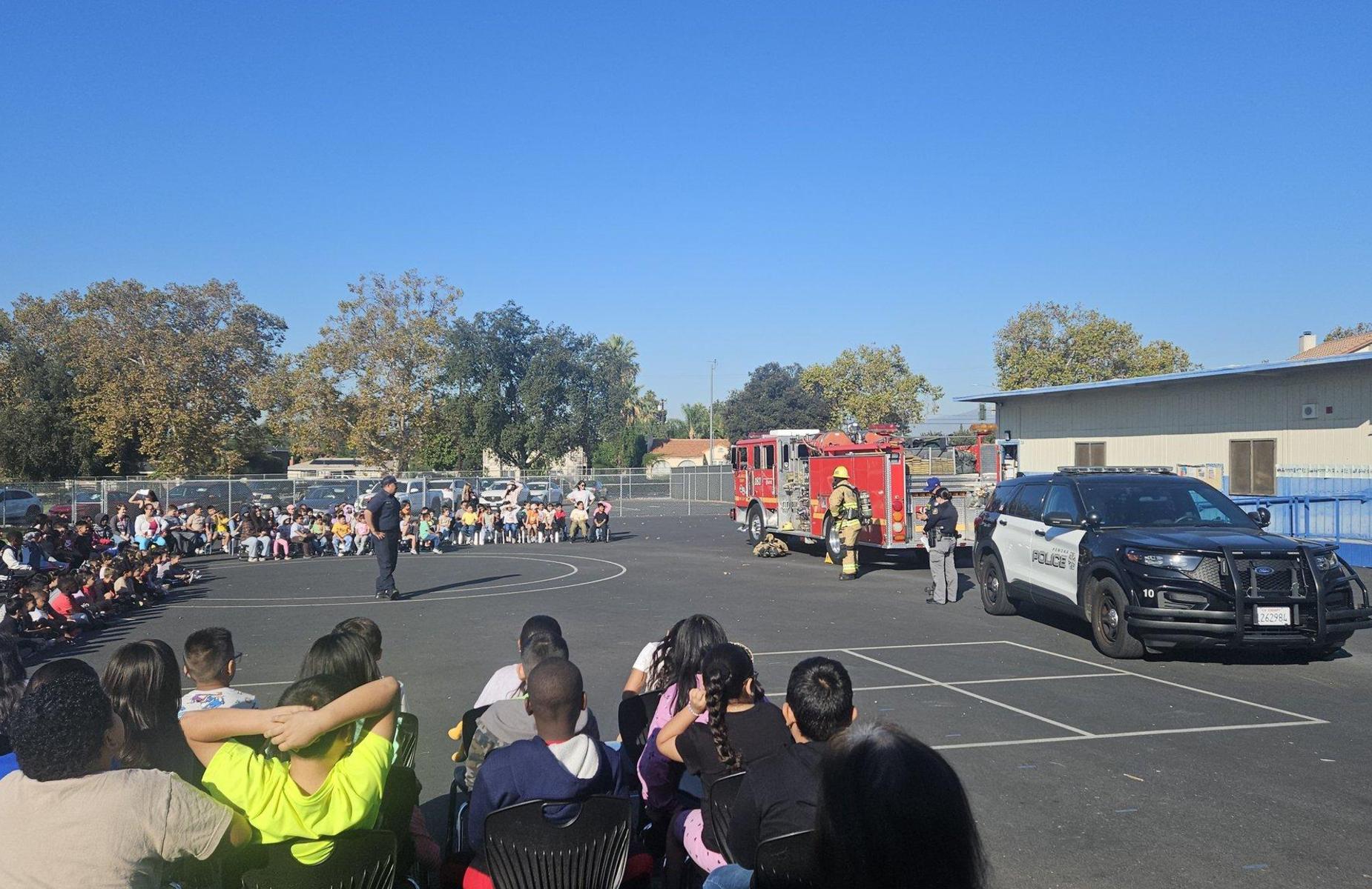 students look at firefighters and police at barfield