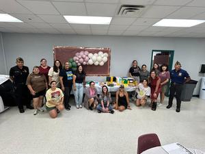 Teachers and VFW members standing with school supplies
