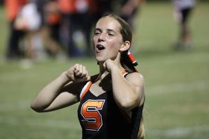 Cheerleader enthusiastically cheers on the field.