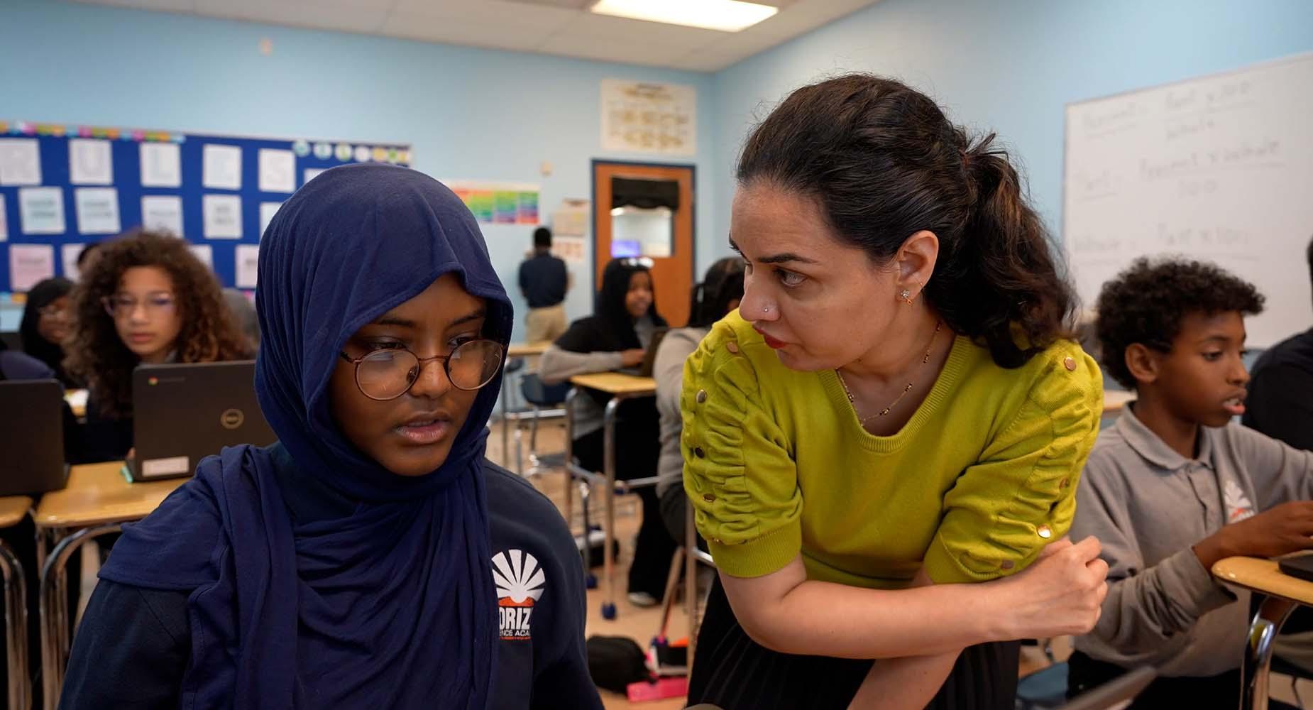 HSA Columbus Middle School student and teacher collaborating during class.