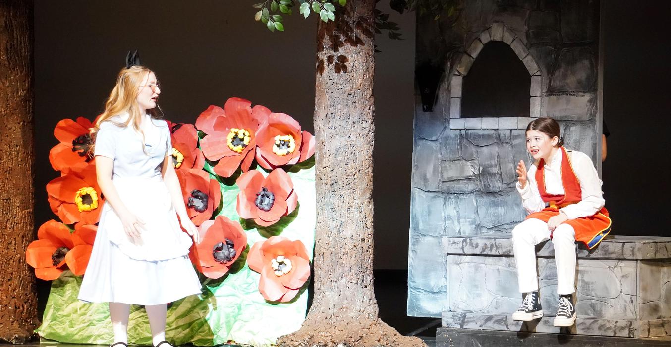 Alice meets Humpty Dumpty in the MS play of "Alice in Wonderland."