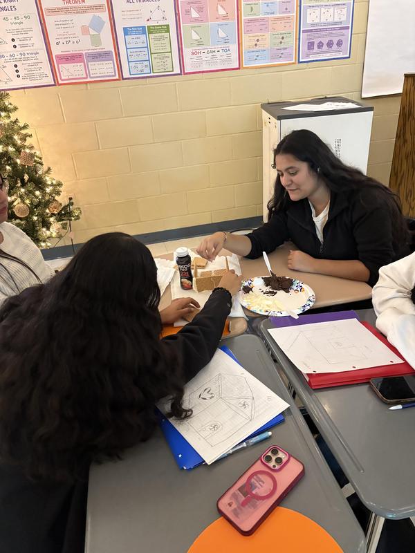 students working on gingerbread house