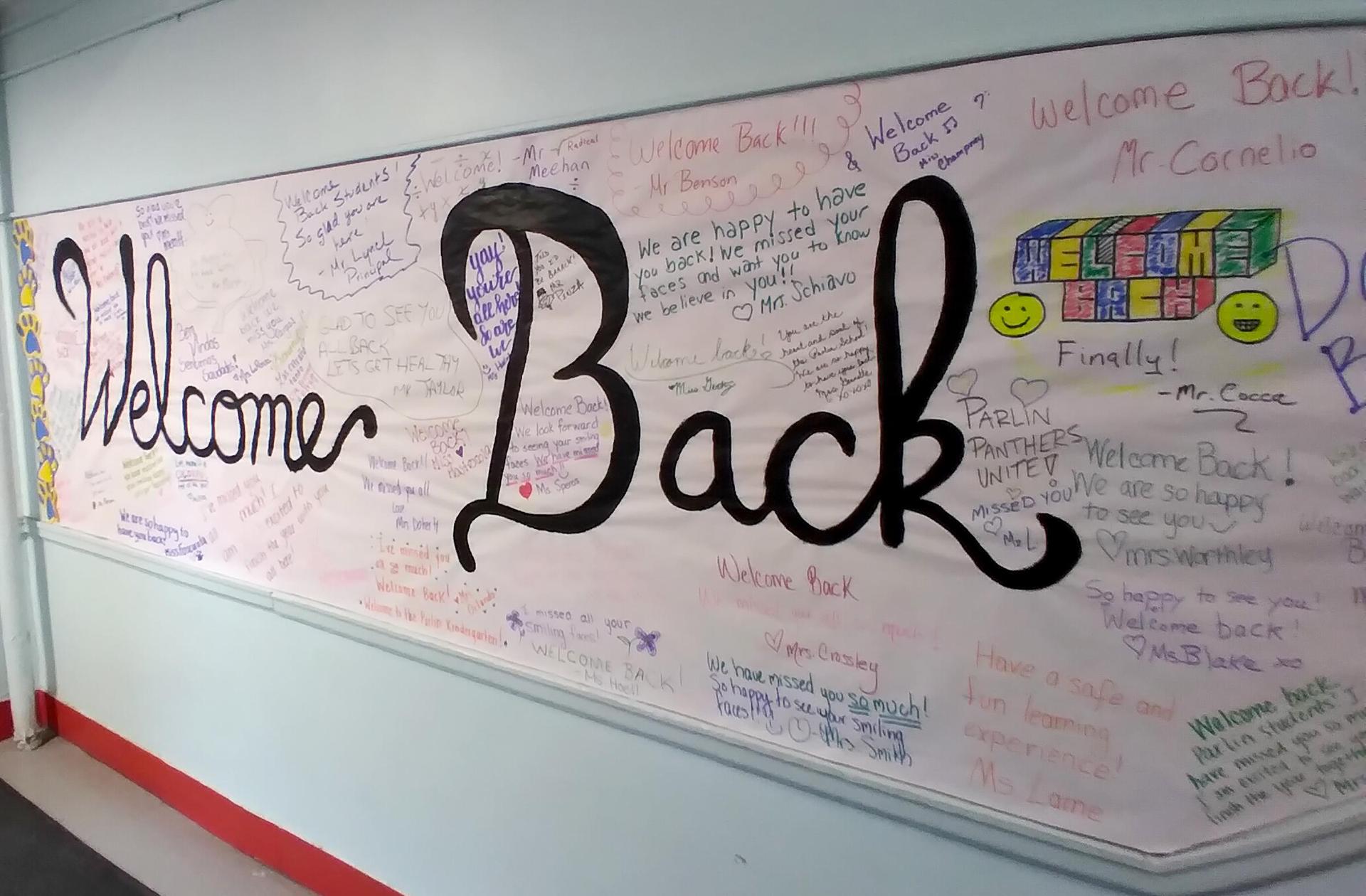 A handmade Welcome Back sign with messages from students and staff at the Parlin
