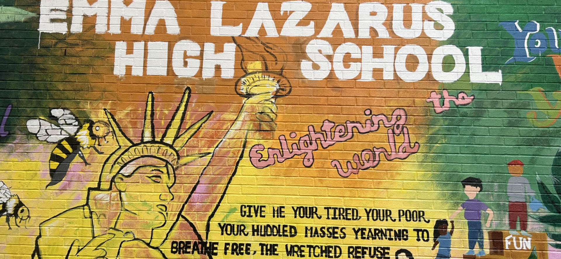 Mural featuring Statue of Liberty and text about enlightenment and acceptance.