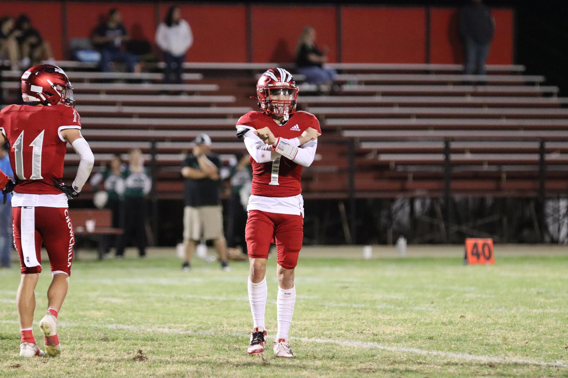 varsity football players in action against Riverdale