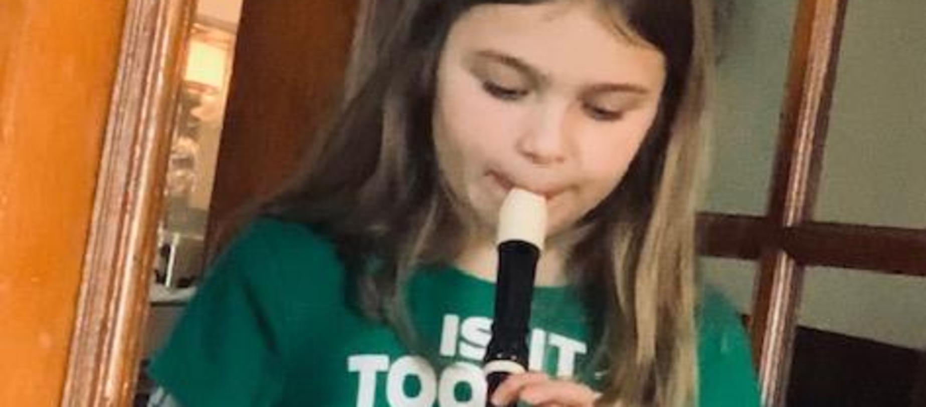 student playing her recorder
