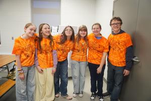 Students show off their OM t-shirts.