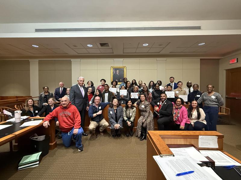 Students, attorney mentors, school staff and jurors pose after the trial