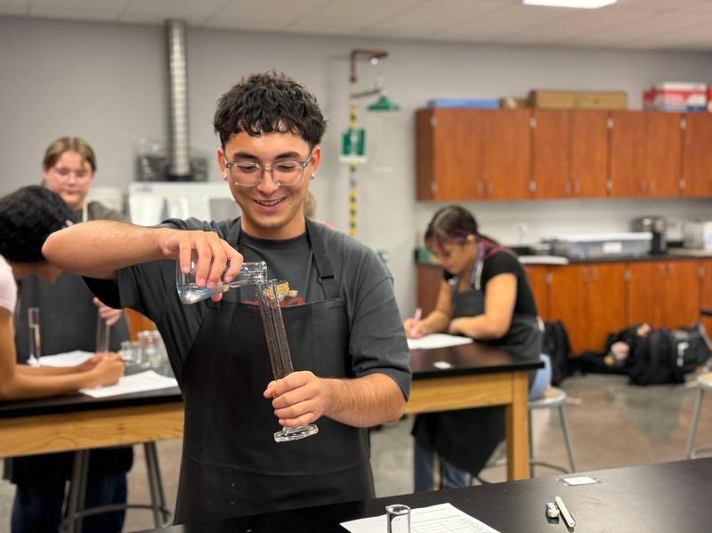 students mixing liquids in beakers