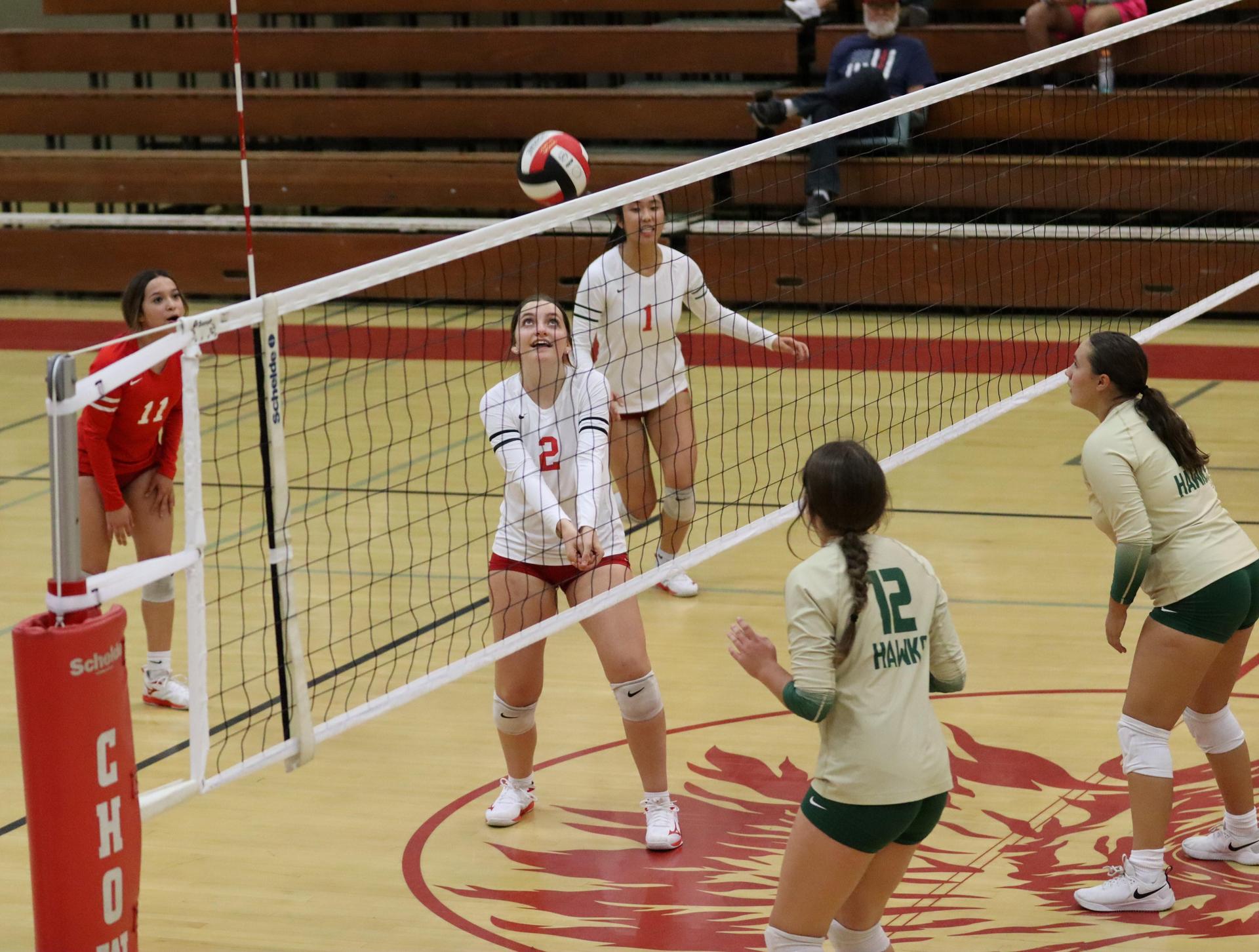 varsity volleyball players in action against liberty