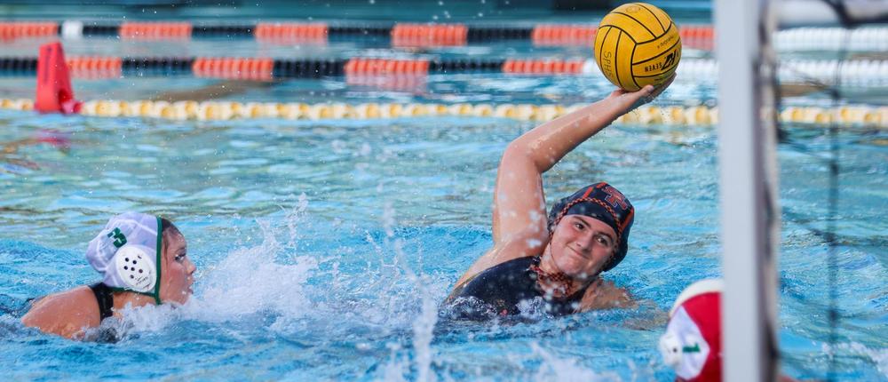 girl holding waterpolo ball in the pool