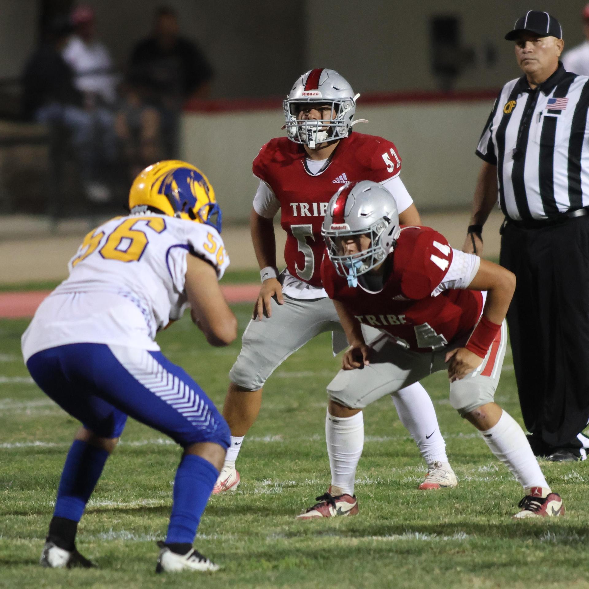 Varsity football players in action against Parlier 139