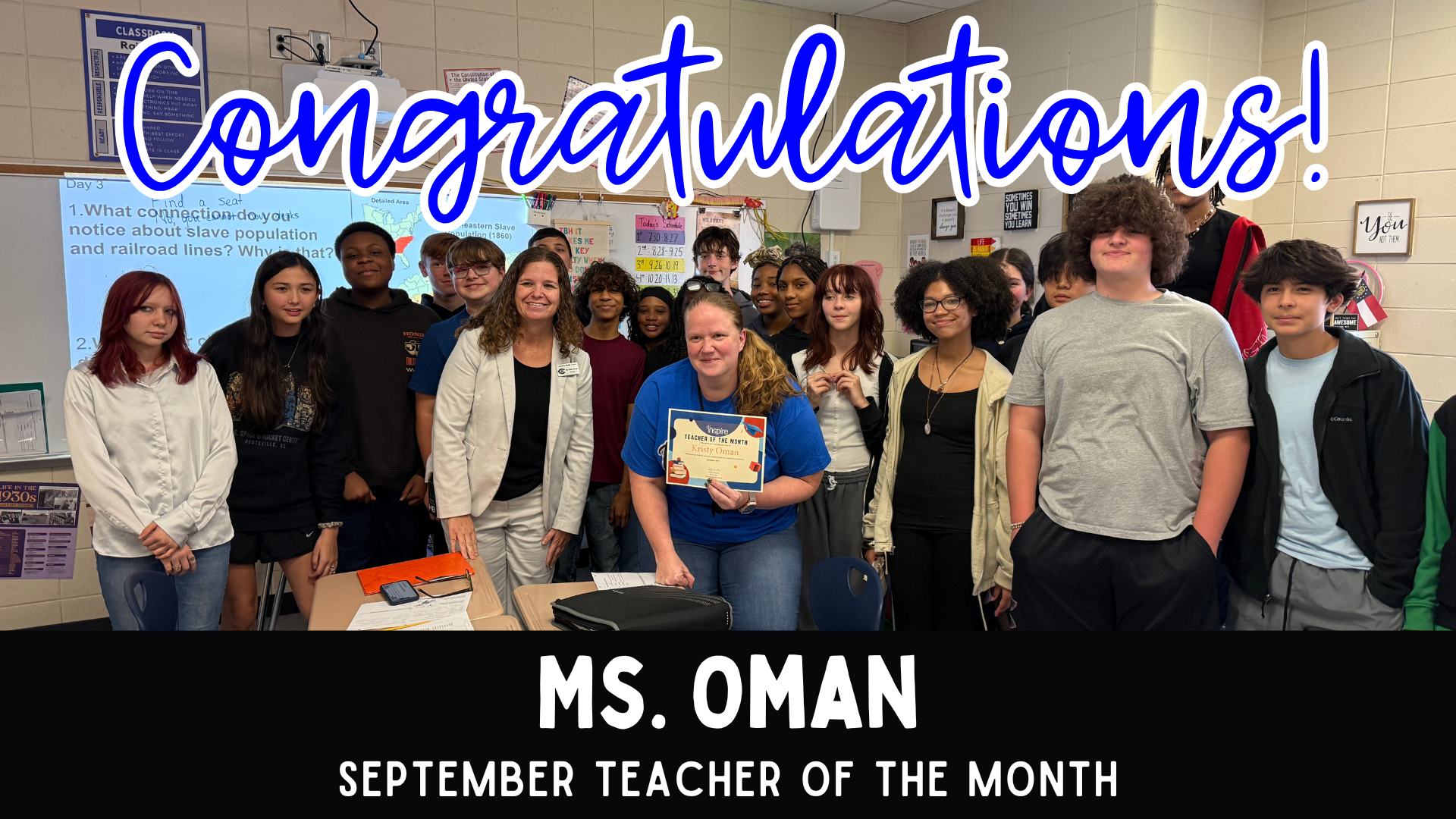 A group of students and teachers celebrating Ms. Oman as September Teacher of the Month.