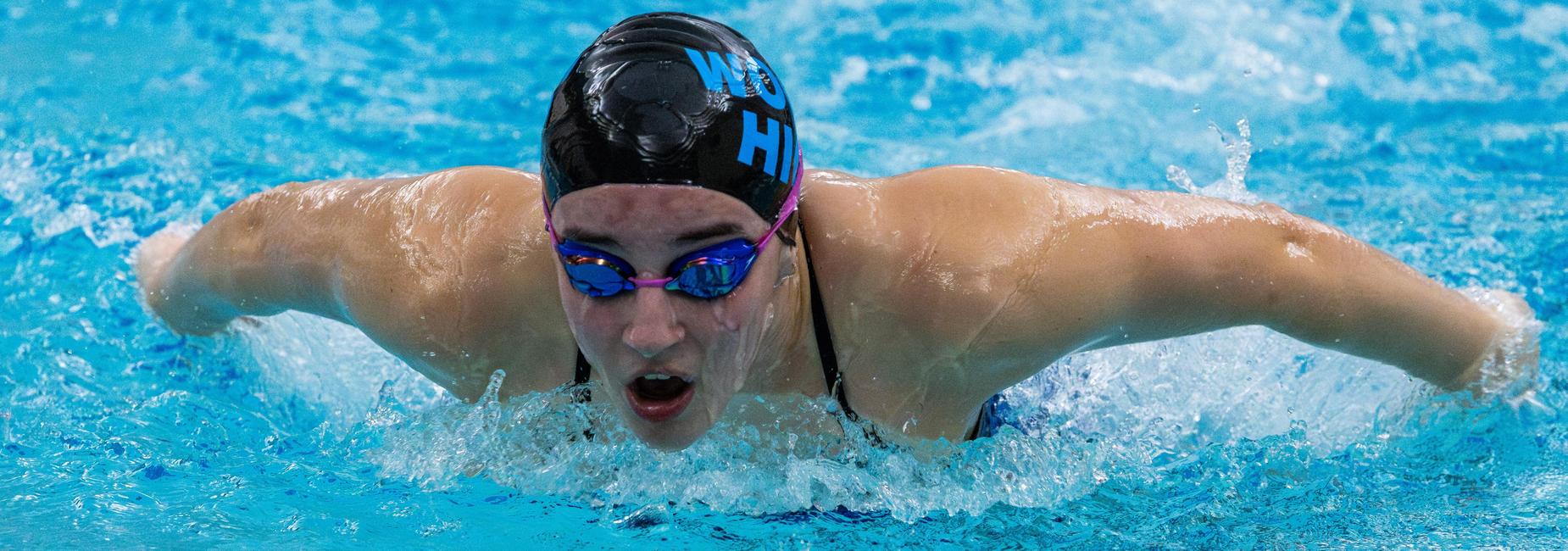 A member of the girls swim team in the pool