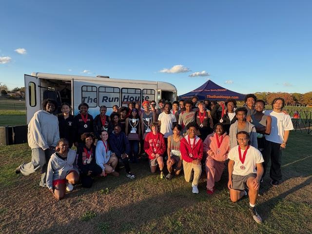 boys and girls cross country teams with their trophies