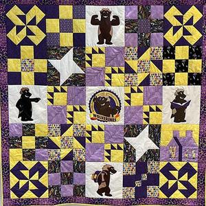 A purple and gold quilt.