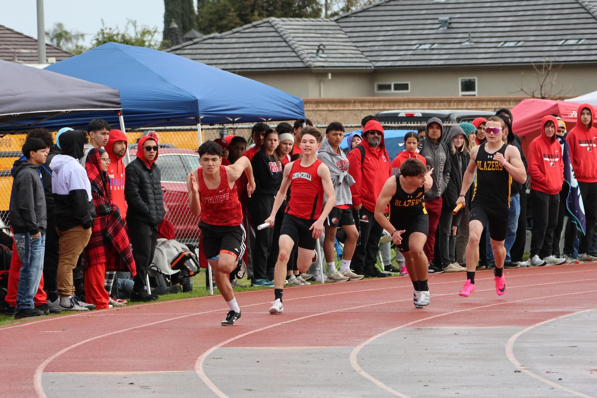junior varsity boys running the four by 100 meter relay
