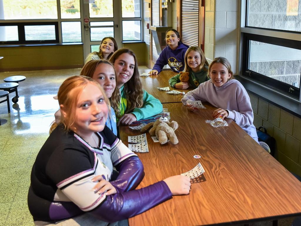 Students sitting at a table in the cafeteria for an after school club.