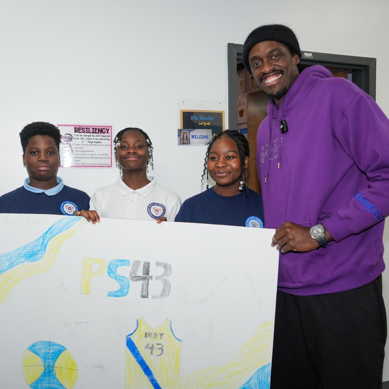 Pascal Siakam posing with students