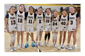 A group of girls wearing basketball uniforms