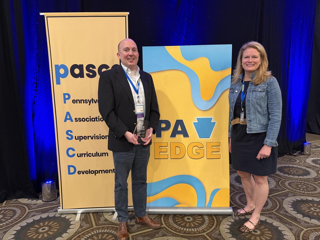 Dr. Donnelly and Dr. O'Connell standing in front of the PA Edge Award signs, where Dr. Donnelly received an award,