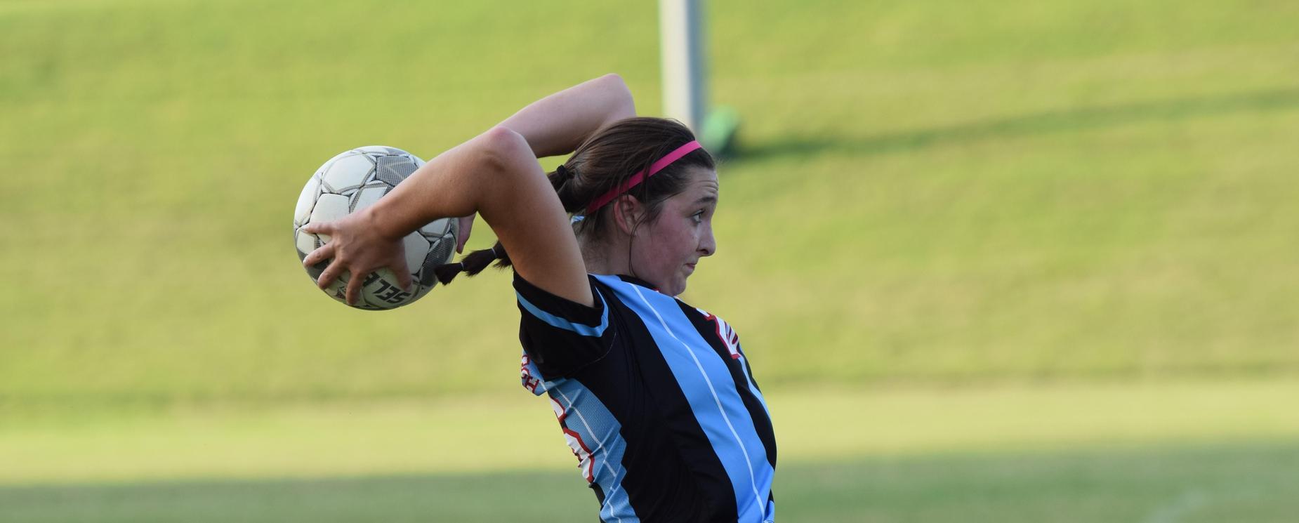 Soccer player throwing ball