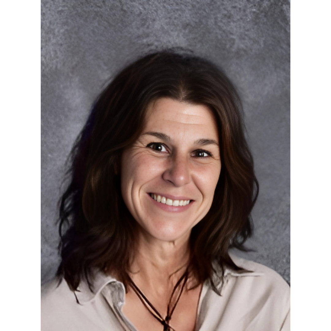 a person in a white shirt smiling at the camera